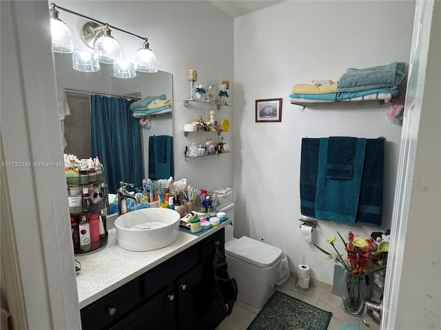 bathroom with vanity, walk in shower, tile patterned floors, and toilet