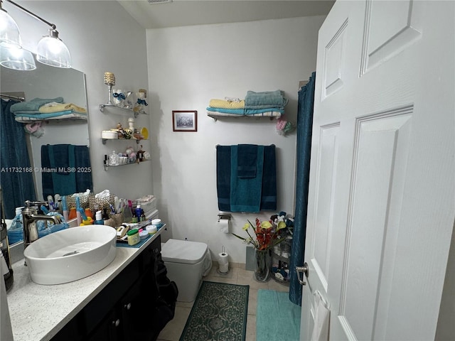 bathroom with vanity, tile patterned floors, and toilet