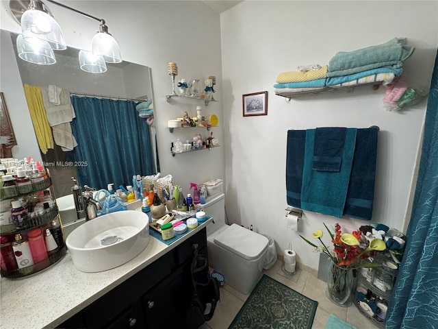 bathroom featuring tile patterned floors, toilet, and vanity