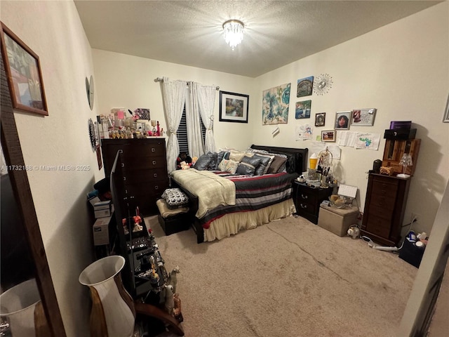 bedroom featuring carpet and a textured ceiling