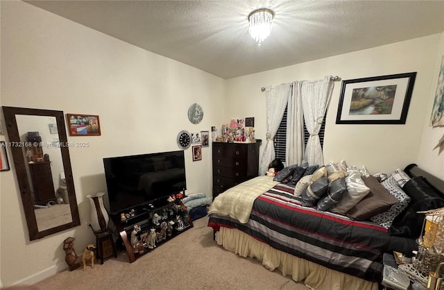 bedroom with carpet and a textured ceiling