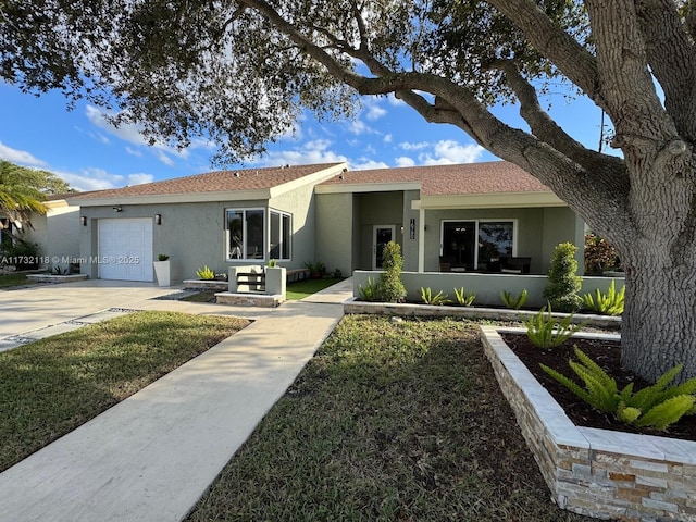 ranch-style house with a garage and a front lawn