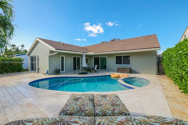 view of swimming pool featuring a patio and an in ground hot tub