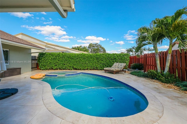 view of pool with an in ground hot tub and a patio