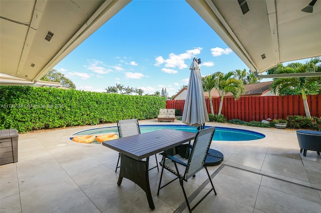 view of patio with a pool with hot tub