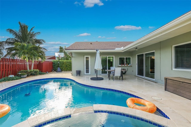 view of swimming pool with an in ground hot tub and a patio