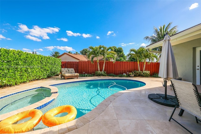 view of swimming pool with a patio area and an in ground hot tub