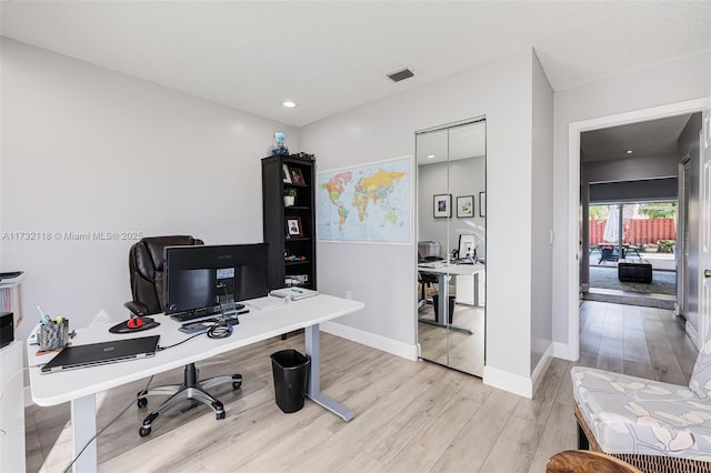 office space with light hardwood / wood-style floors