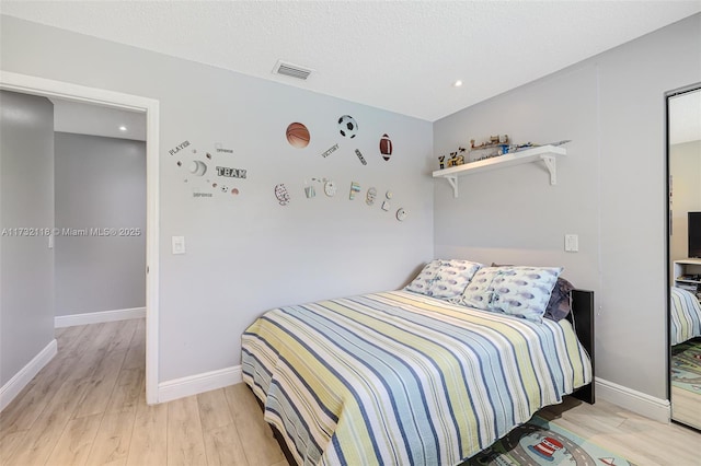 bedroom with light hardwood / wood-style flooring