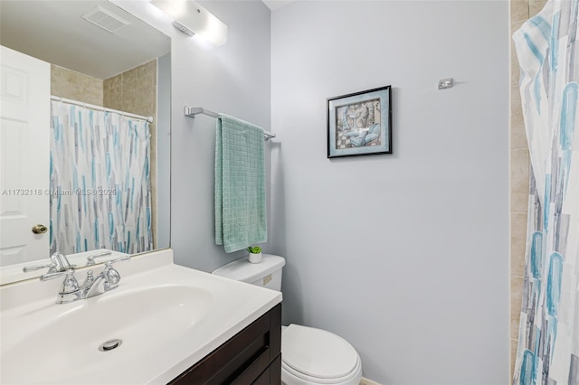 bathroom featuring vanity, walk in shower, and toilet