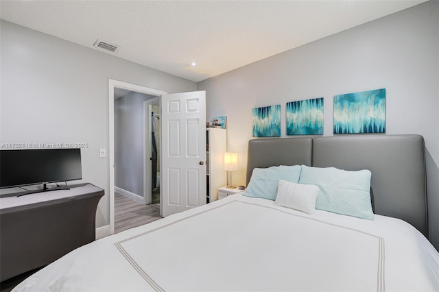 bedroom with light hardwood / wood-style floors