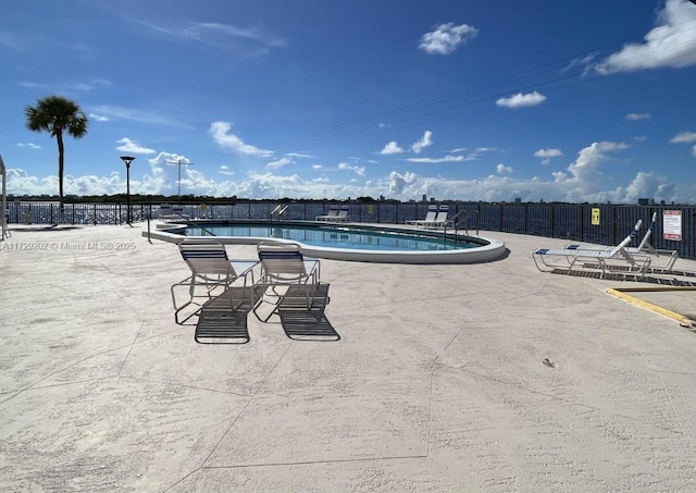 view of swimming pool with a patio area