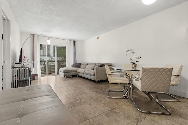 tiled living room with a textured ceiling