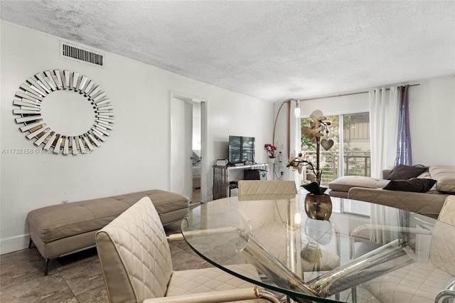 dining space featuring a textured ceiling