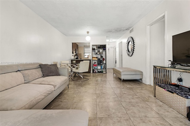 living room with light tile patterned floors and a textured ceiling