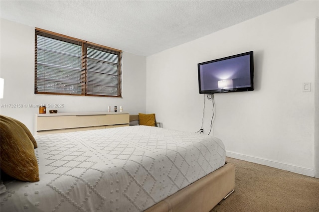 bedroom with carpet floors and a textured ceiling