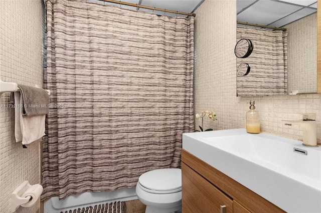 bathroom with tasteful backsplash, vanity, and toilet