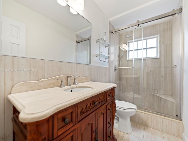 bathroom with vanity, tile walls, walk in shower, and toilet