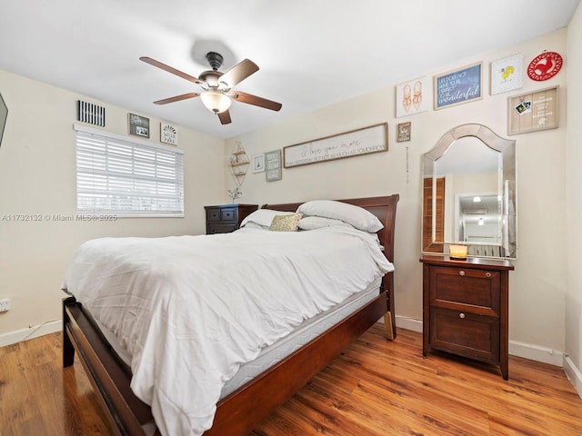 bedroom with ceiling fan and light hardwood / wood-style floors