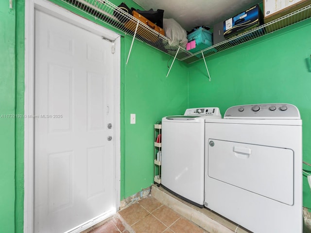 washroom featuring washing machine and clothes dryer and light tile patterned floors