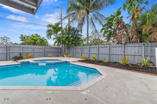 view of swimming pool with an in ground hot tub