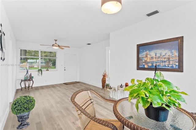 sitting room featuring ceiling fan and light hardwood / wood-style floors