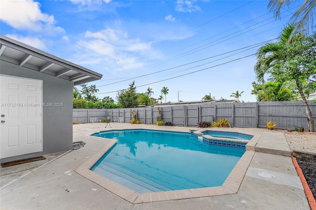 view of pool featuring an in ground hot tub and a patio