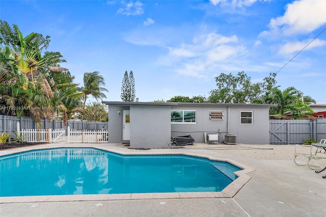 view of pool with central AC and a patio