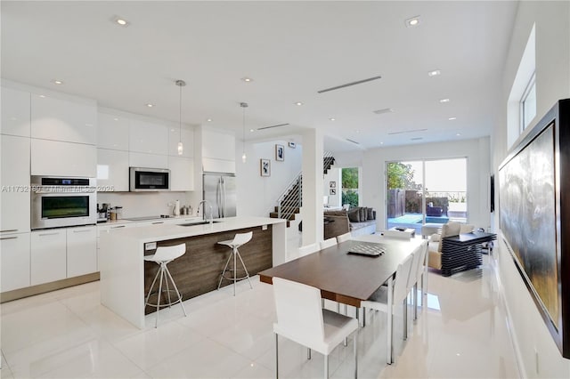 tiled dining room with sink