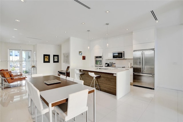 dining space with sink and light tile patterned floors