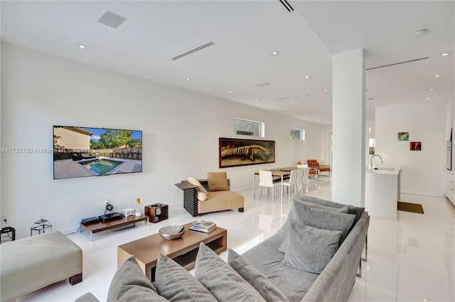 living room featuring light tile patterned flooring and sink