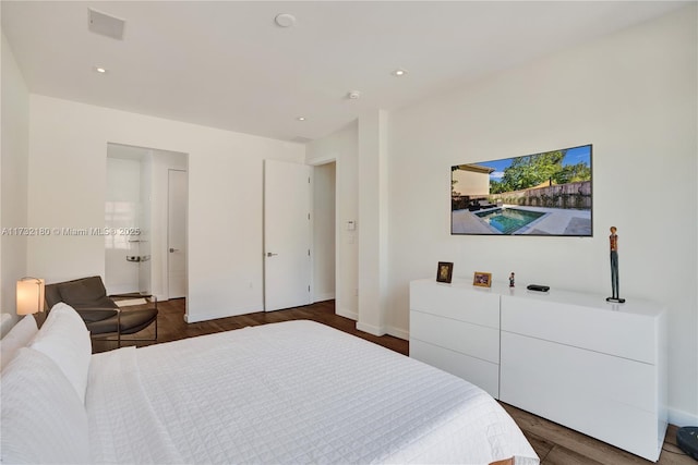 bedroom with dark hardwood / wood-style floors