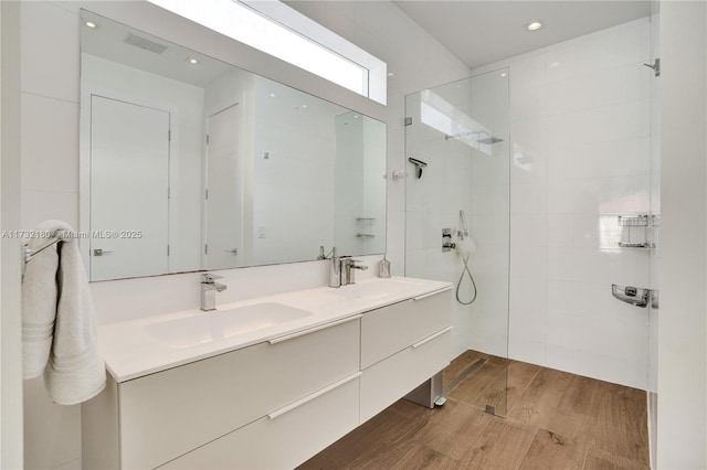 bathroom featuring vanity and a tile shower