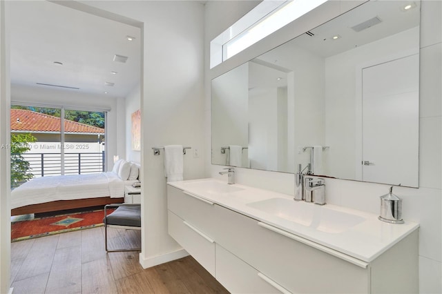 bathroom featuring plenty of natural light, wood-type flooring, and vanity