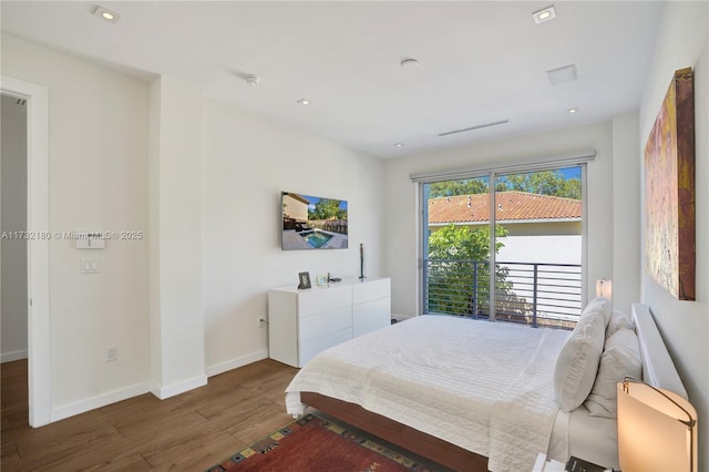 bedroom with dark wood-type flooring