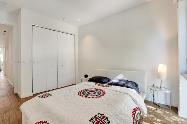 bedroom featuring light hardwood / wood-style floors and a closet