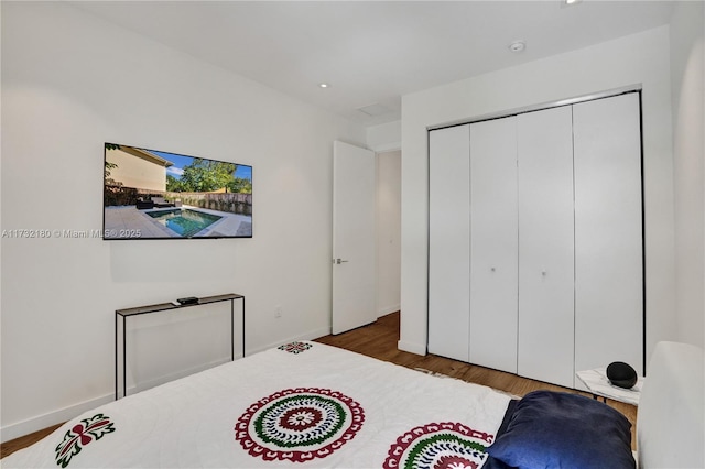 bedroom featuring dark hardwood / wood-style floors and a closet