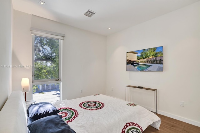 bedroom with wood-type flooring