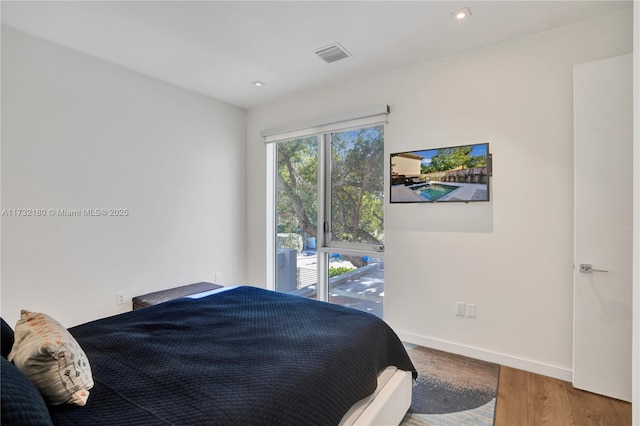 bedroom with hardwood / wood-style flooring