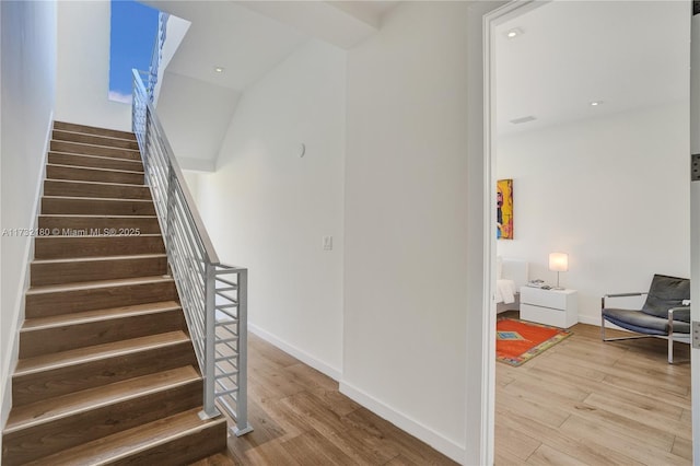 stairway featuring wood-type flooring