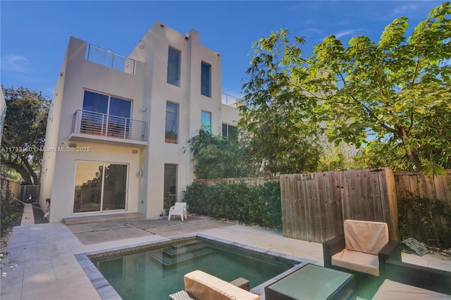 back of property with a fenced in pool, central AC, a patio area, and a balcony