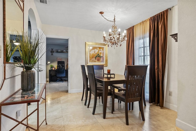 dining area with an inviting chandelier