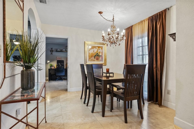 18020 SW 89th Ave, Palmetto Bay, FL 33157 - dining room featuring arched walkways, an inviting chandelier, baseboards, and light tile patterned floors