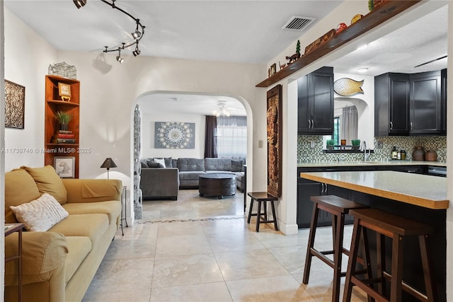 tiled living room featuring sink