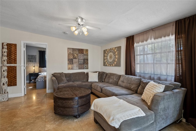 tiled living room featuring ceiling fan and a textured ceiling