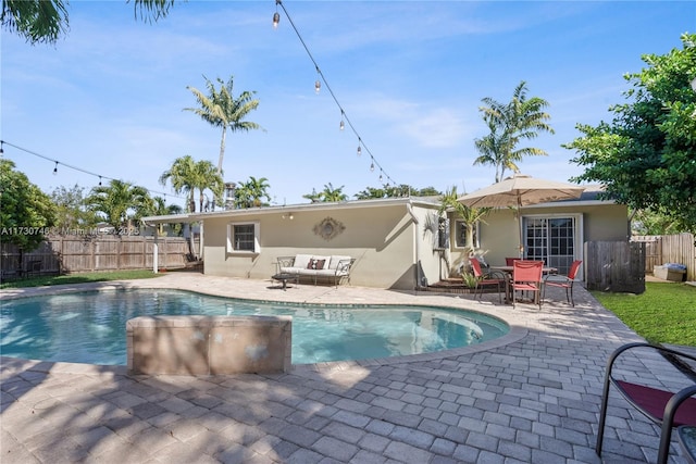 view of pool featuring an outdoor living space and a patio area