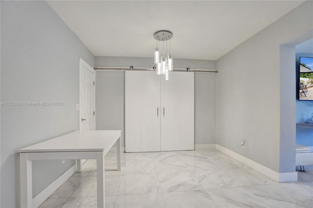 unfurnished bedroom featuring a barn door