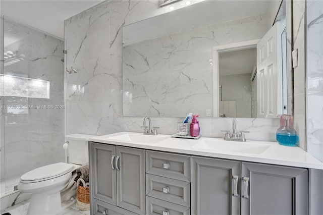 bathroom featuring vanity, tile walls, and toilet