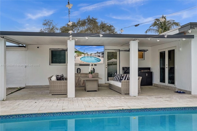 back of property with a patio, an outdoor hangout area, and french doors