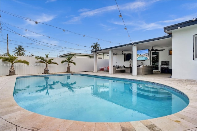 view of swimming pool with outdoor lounge area, a patio, and ceiling fan